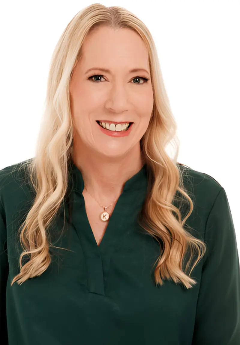 Smiling woman with long blonde hair.